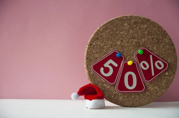 Big sale 50%, fifty percent with Santa hat over pink background. — Stock Photo, Image