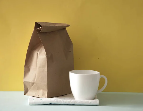 Blank brown paper bag and white coffee cup — Stock Photo, Image