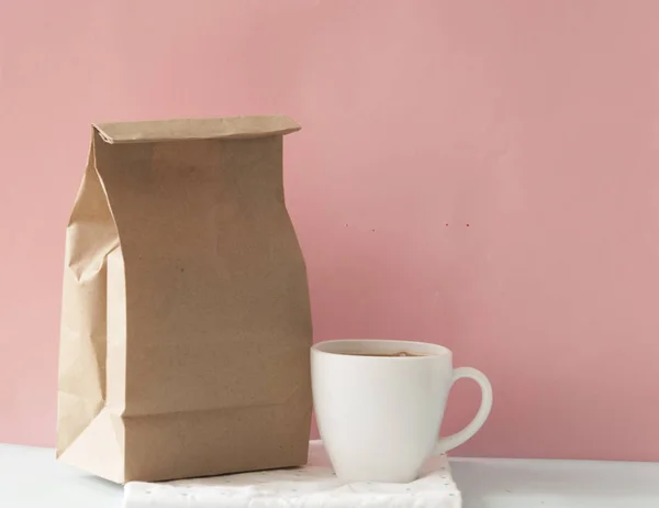 Blank brown paper bag and white coffee cup — Stock Photo, Image