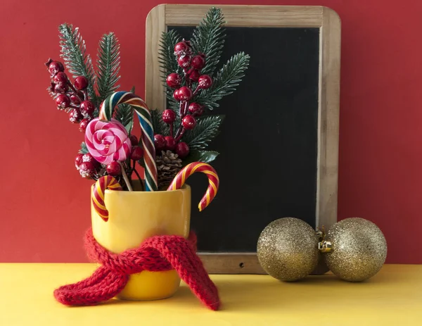 성탄절 사탕에 딸기 홀리 가지가 달린 노란 사탕 — 스톡 사진