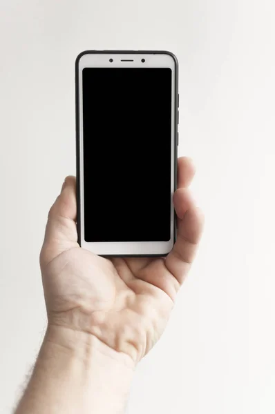 Close-up hand holding phone blank screen — Stock fotografie