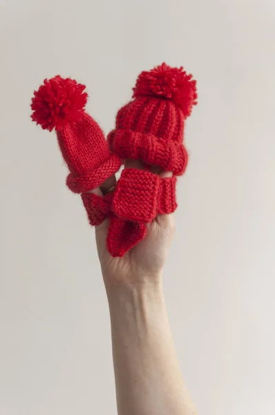 Red knitted hat and scarf on woman hand — Stock Photo, Image