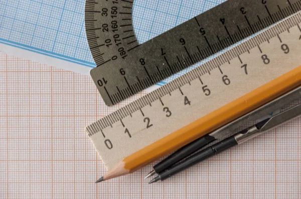 Geometry set with compass,pencil,ruler on graph paper — Stock Photo, Image