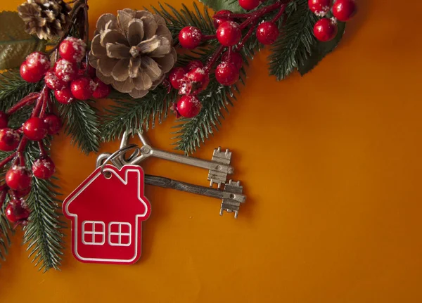 Two vintage key and Christmas balls on red paper background