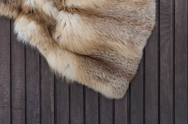 Textures red fox fur on wooden background. Top view.