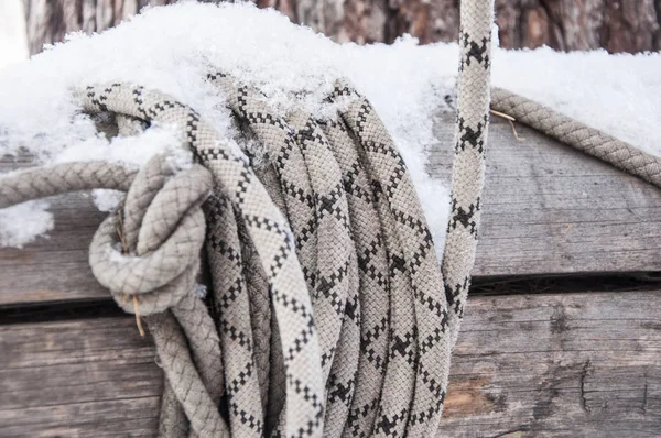 Ξύλο κούτσουρο τυλιγμένο με σχοινί και χιόνι καλύπτονται — Φωτογραφία Αρχείου