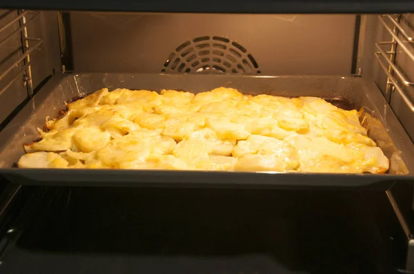 home cooking potatos with chicken in oven.