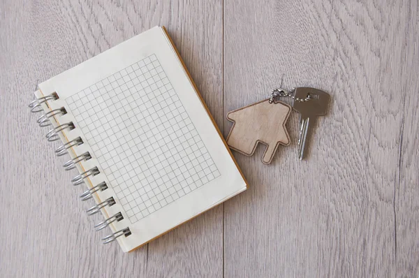 House key with home keyring on wood background, copy space — 스톡 사진