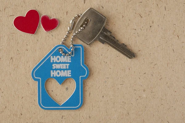 Blue house key on paper background. Minimal creative style — Stock Photo, Image