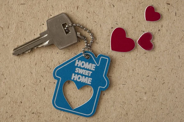 Blue house key on paper background. Minimal creative style — Stock Photo, Image