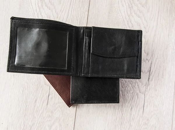 Three leather wallets on wooden table — Stockfoto
