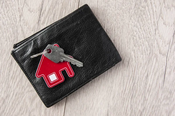 Wallet and key on wood background — Stock Photo, Image