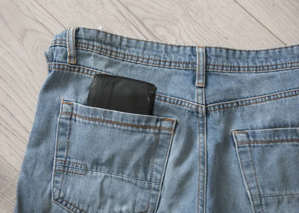 Brown wallet in the blue jeans pocket — Stock Photo, Image