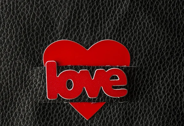 Word Love with red hearts on black leather background. Greeting — Stock Photo, Image