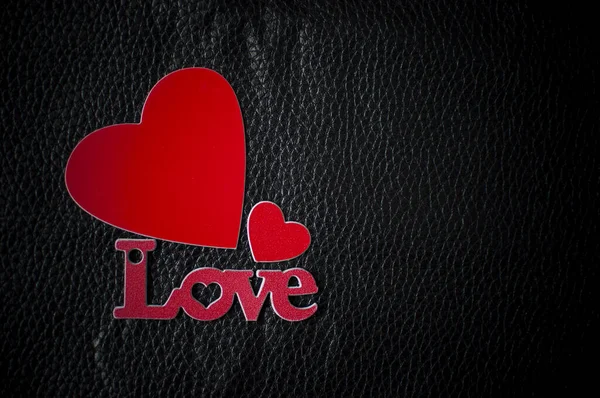 Valentine's Day background. Word Love with red hearts on black l — 스톡 사진