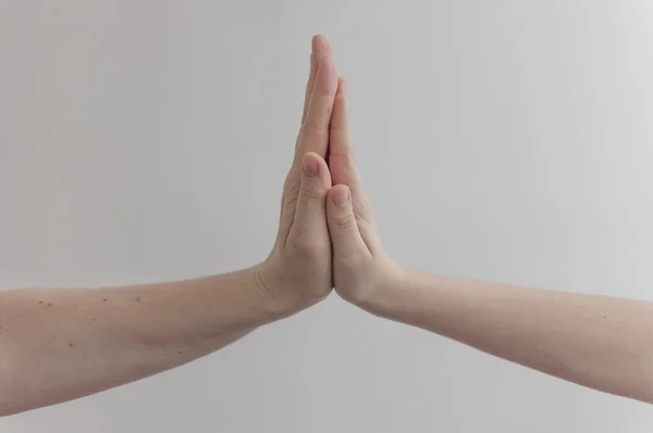 child making hi five gesture over white wall background