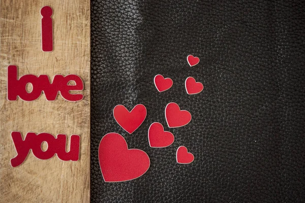 Valentine's Day card. Word Love with red hearts on wooden backg — Stock Photo, Image