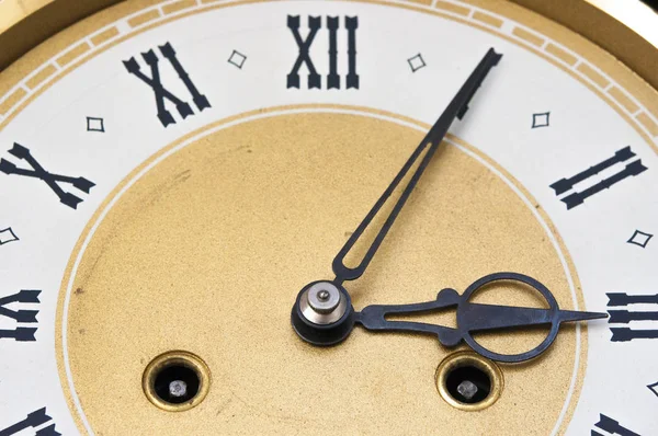 Golden and white clock in front — Stock Photo, Image