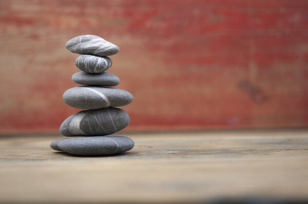 balancing pebbles on wooden table, space for text. Zen concept