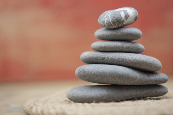 balancing pebbles with hemp rope on wooden table, space for text. Zen concept