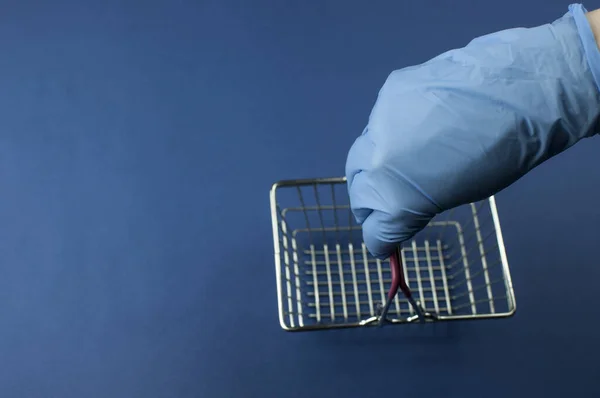 Carrinho Supermercado Vazio Mão Mulher Azul Luvas Médicas Sobre Fundo — Fotografia de Stock