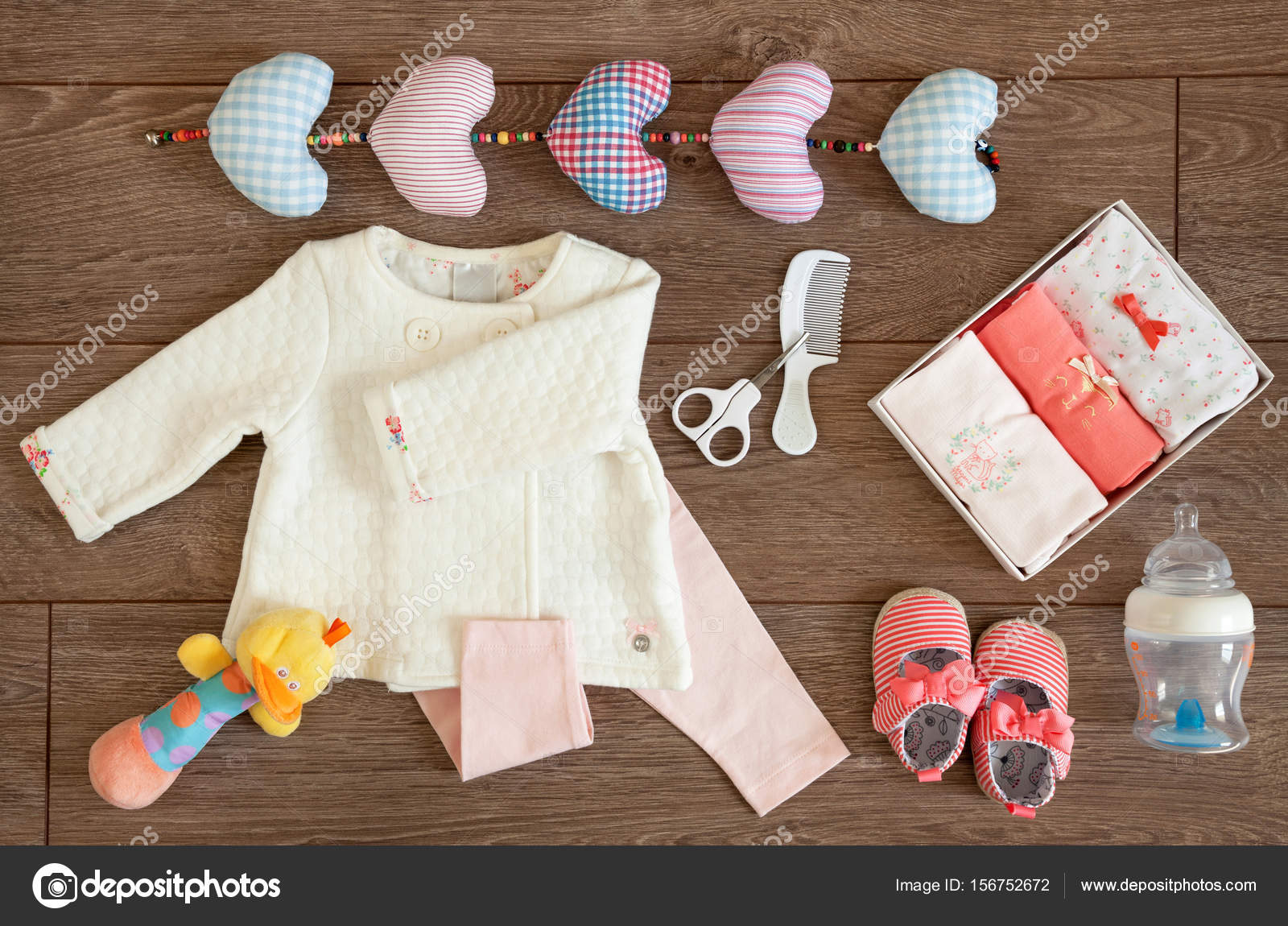 Baby Girl Clothes and Colorful Toys on a Tabletop Flat Lay Stock by ©Borna_mir 156752672