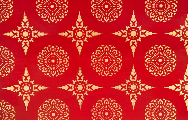 Ancient Traditional Thai Design Painting with Golden Stars and Flowers on Red Background