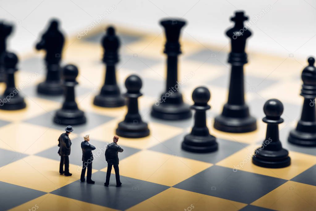 Businessmen on a chessboard. Business strategy concept