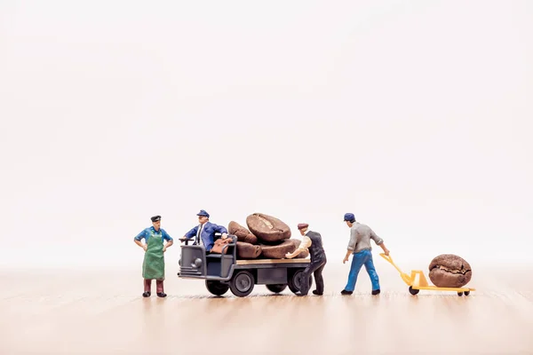 Miniature workers with truck loaded with coffee beans — Stock Photo, Image