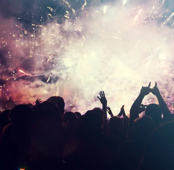 Cheering crowd and fireworks - New Year concept — Stock Photo, Image