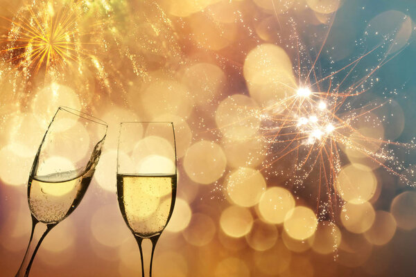 Champagne glasses on sparkling background