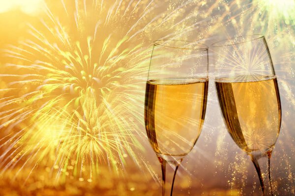 Champagne glasses on sparkling background