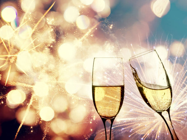 Champagne glasses on sparkling background