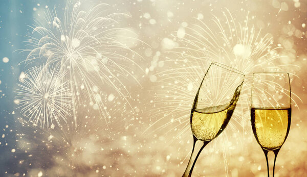 Champagne glasses on sparkling background
