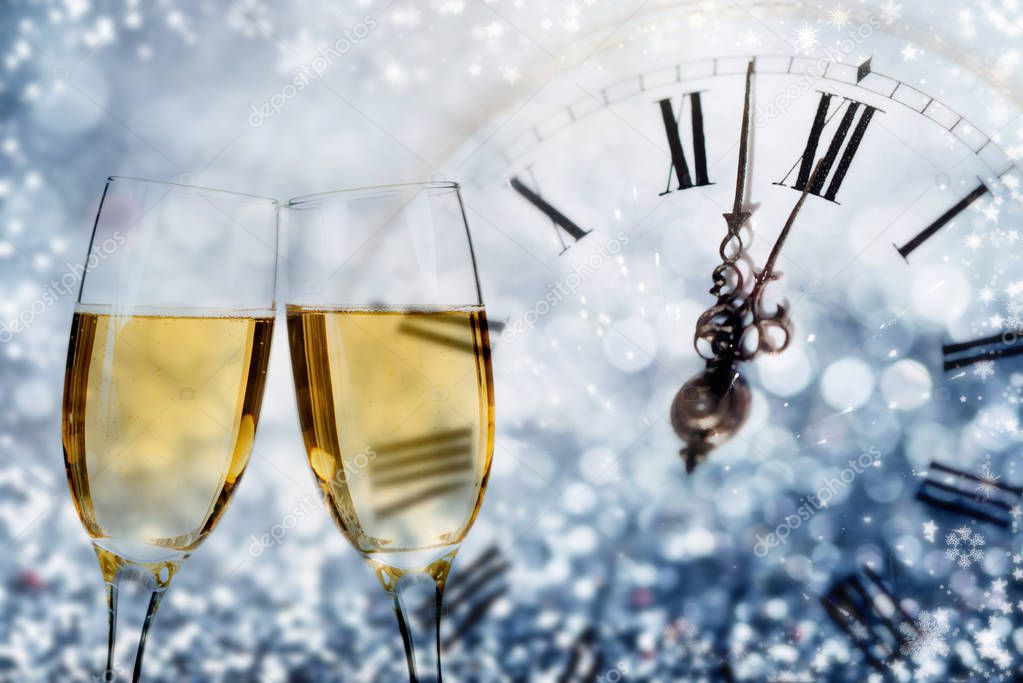 Champagne and clock on sparkling background