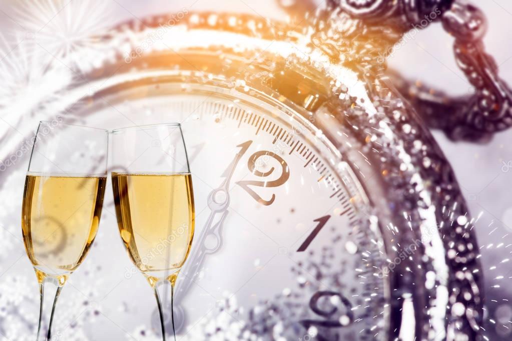 Champagne and clock on sparkling background