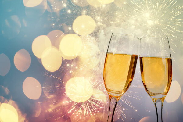 Champagne glasses on sparkling background