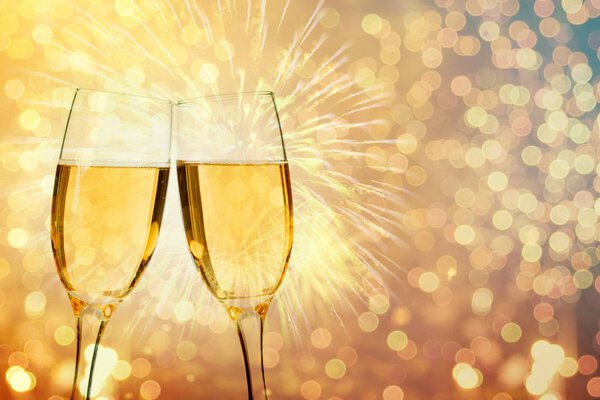 Champagne glasses on sparkling background