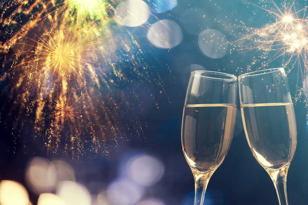 Champagne glasses on sparkling background