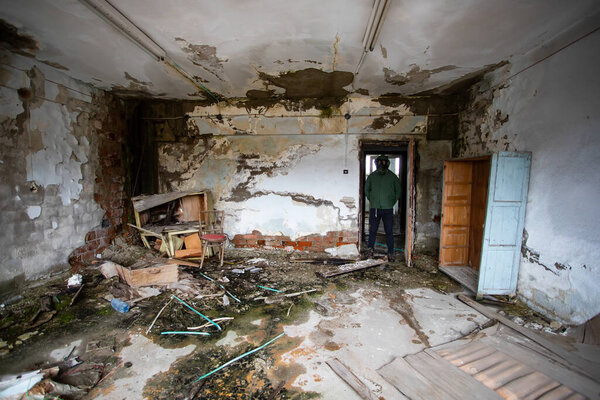  Post apocalyptic survivor in gas mask in a ruined building. Environmental disaster, armageddon concept.