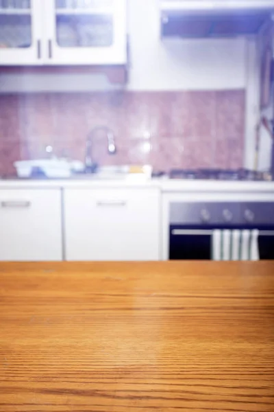 Wood table top on blurred kitchen room background.