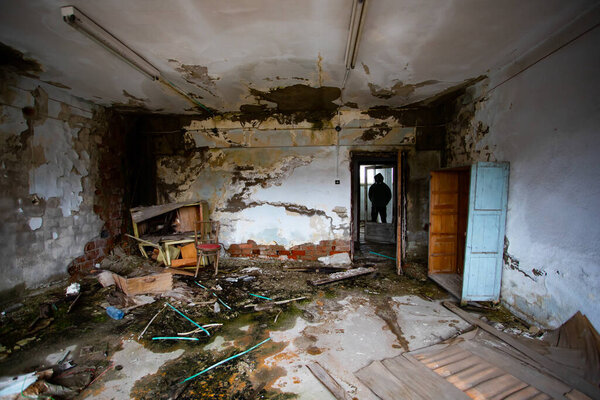  Post apocalyptic survivor in gas mask in a ruined building. Environmental disaster, armageddon concept.