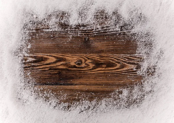 Sneeuwvlokken op houten achtergrond — Stockfoto