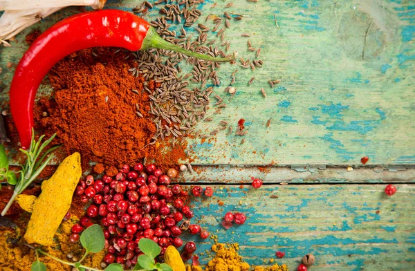 Various colorful spices on wooden table — Stock Photo, Image