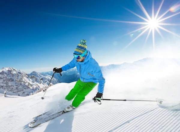 Skier skiing downhill in high mountains — Stock Photo, Image