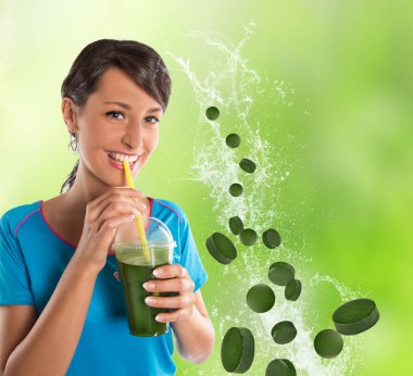 Green vegetable smoothie. Woman living healthy lifestyle drinking vegetable smoothies. clipart