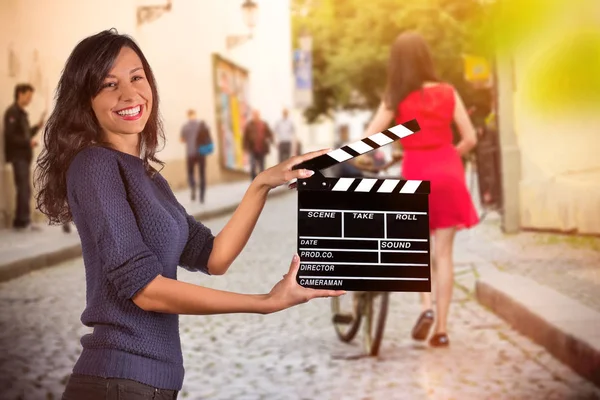 Clapperboard sign hold by female hands.