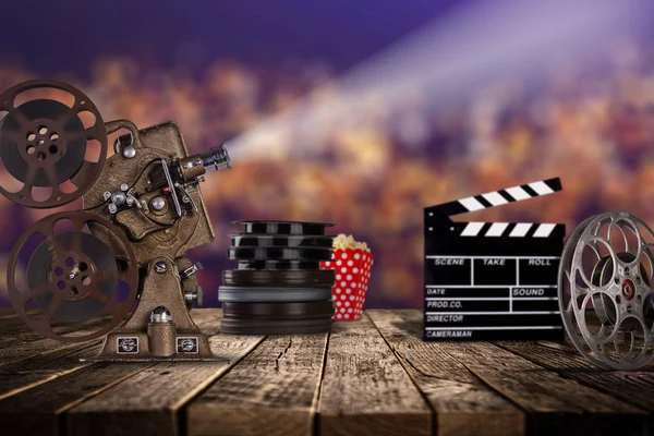 Cinema concept of vintage film reels, clapperboard and projector. — Stock Photo, Image