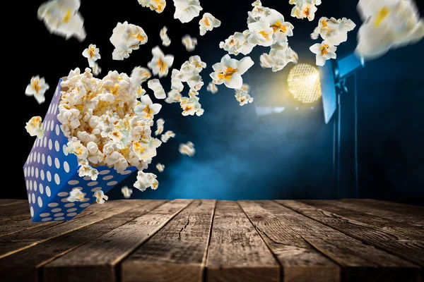 Popcorn explosion on old wooden table. — Stock Photo, Image