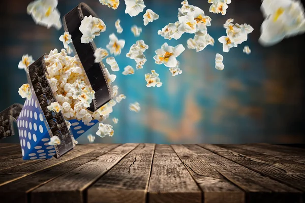 Popcorn explosion on old wooden table. — Stock Photo, Image